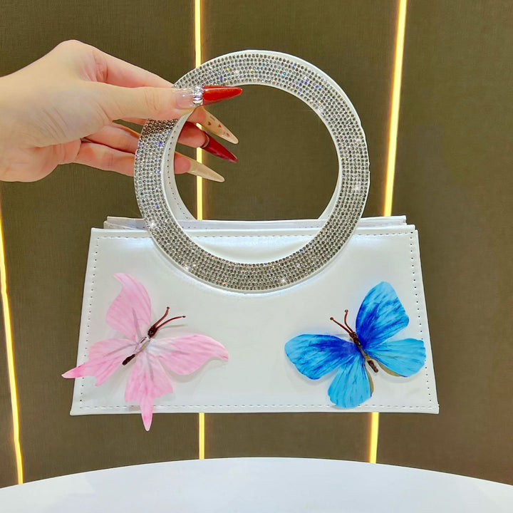 Künstlerische mit Schmetterlingen verzierte Handtasche