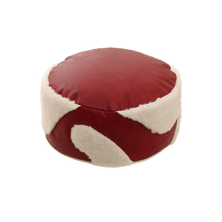 Runde Sitzpouf mit Kunstlederbezug und Sherpa‑Applikationen