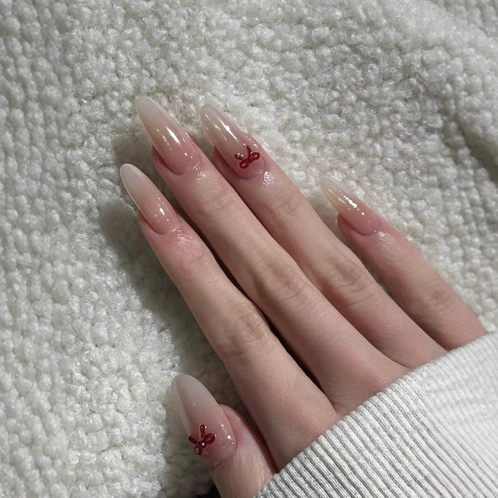 Elegante Stiletto Press-On Nägel mit dekorativen Schleifenakzenten Karnz