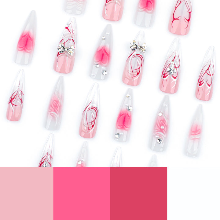 Kunstvolle Stiletto-Nägel mit eleganter floralem Akzent und Glitzerverzierungen Karnz