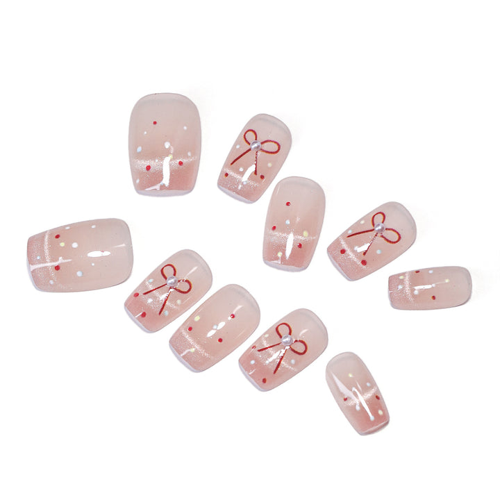 Künstliche Nagelkunst mit eleganten Schleifen und Glitzerakzenten Karnz