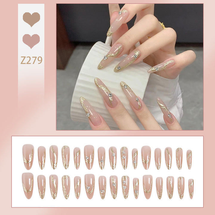 Kunstnagelset mit elegantem Gold-Design und funkelnden Applikationen Karnz