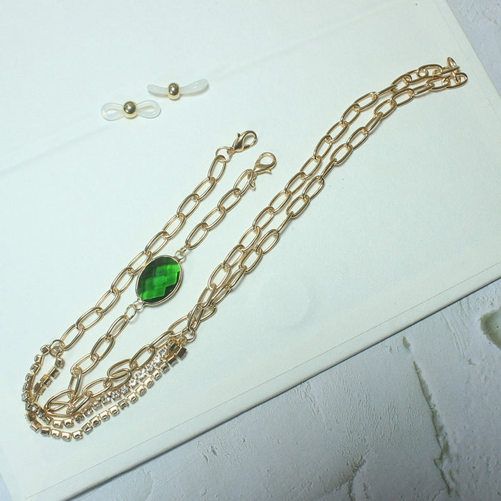 Elegante Kette mit Grünem Stein und Goldenen Akzenten Karnz