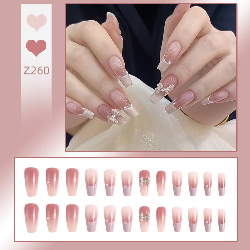 Kunstnagelset mit elegantem Ombre-Design und filigranen Schleifenverzierungen Karnz