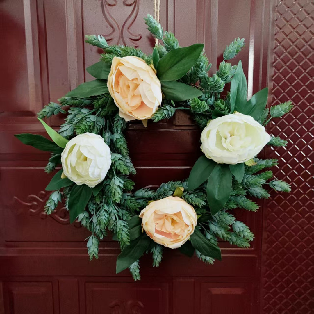 Lebensechter Blumenkranz mit grünen Akzenten