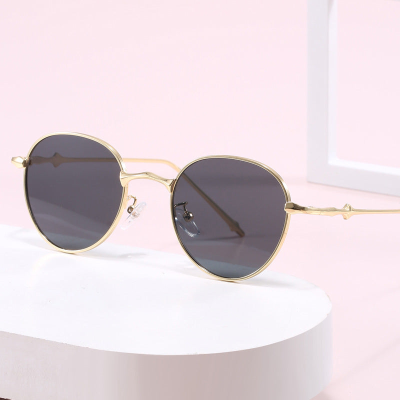 Damen elegante runde Sonnenbrille mit modischem Metallrahmen Karnz