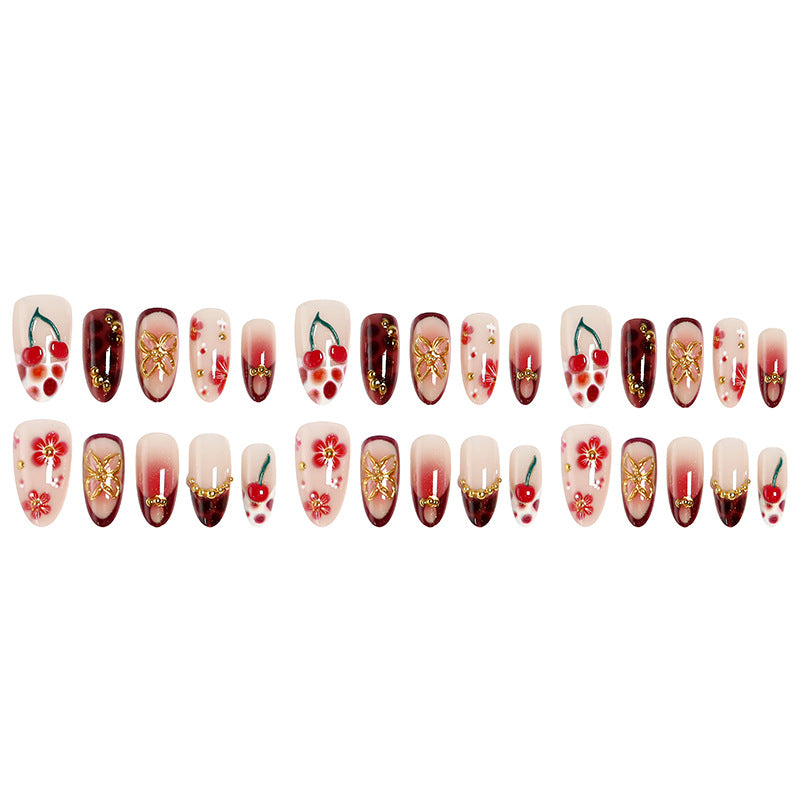 Kunstvolle Nagelspitzen mit fröhlichen Blumen- und Kirschdesign Karnz