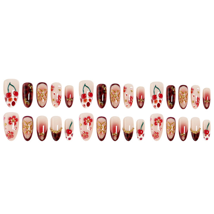 Kunstvolle Nagelspitzen mit fröhlichen Blumen- und Kirschdesign Karnz