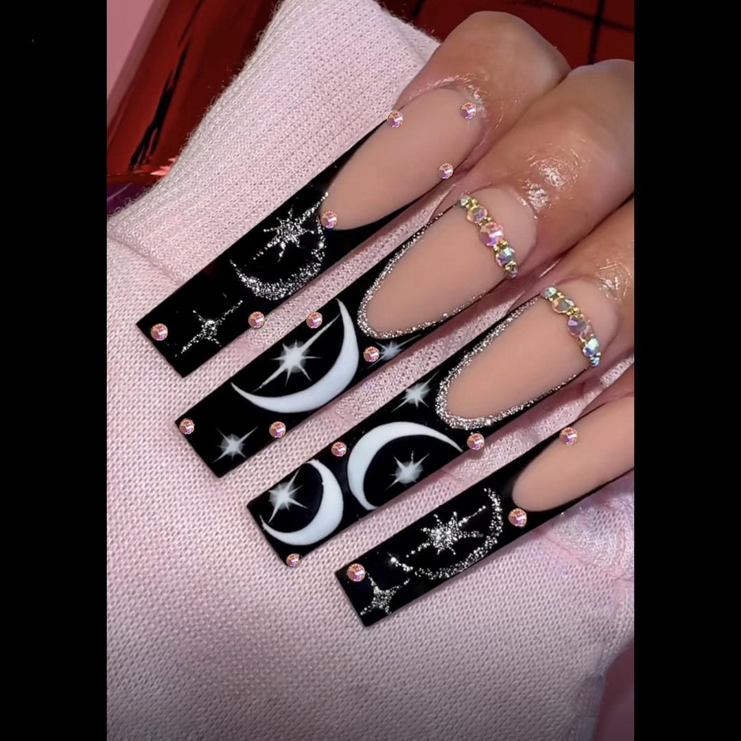 Künstlerisches langes Stiletto Press-On Nagelset mit Mond- und Sternmustern