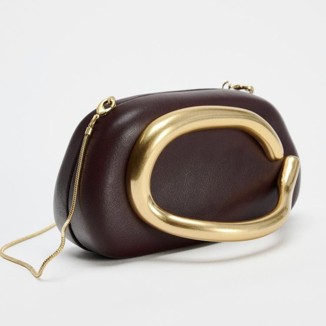 Statement Clutch mit skulpturalem Griff Karnz