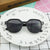 Damen geometrische Sonnenbrille mit transparenter Rahmenstruktur Karnz