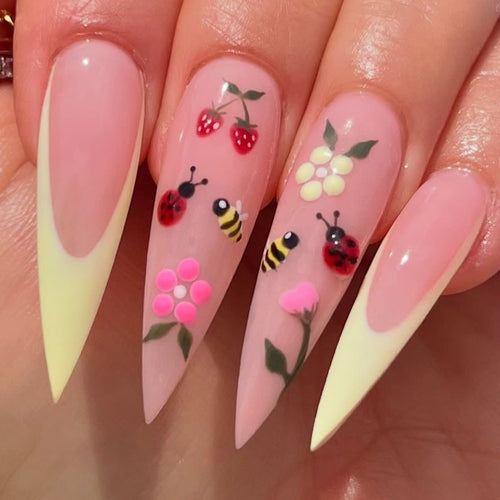 Kunstnagelset mit buntem Frühlingsdesign und eleganten Spitzen Karnz
