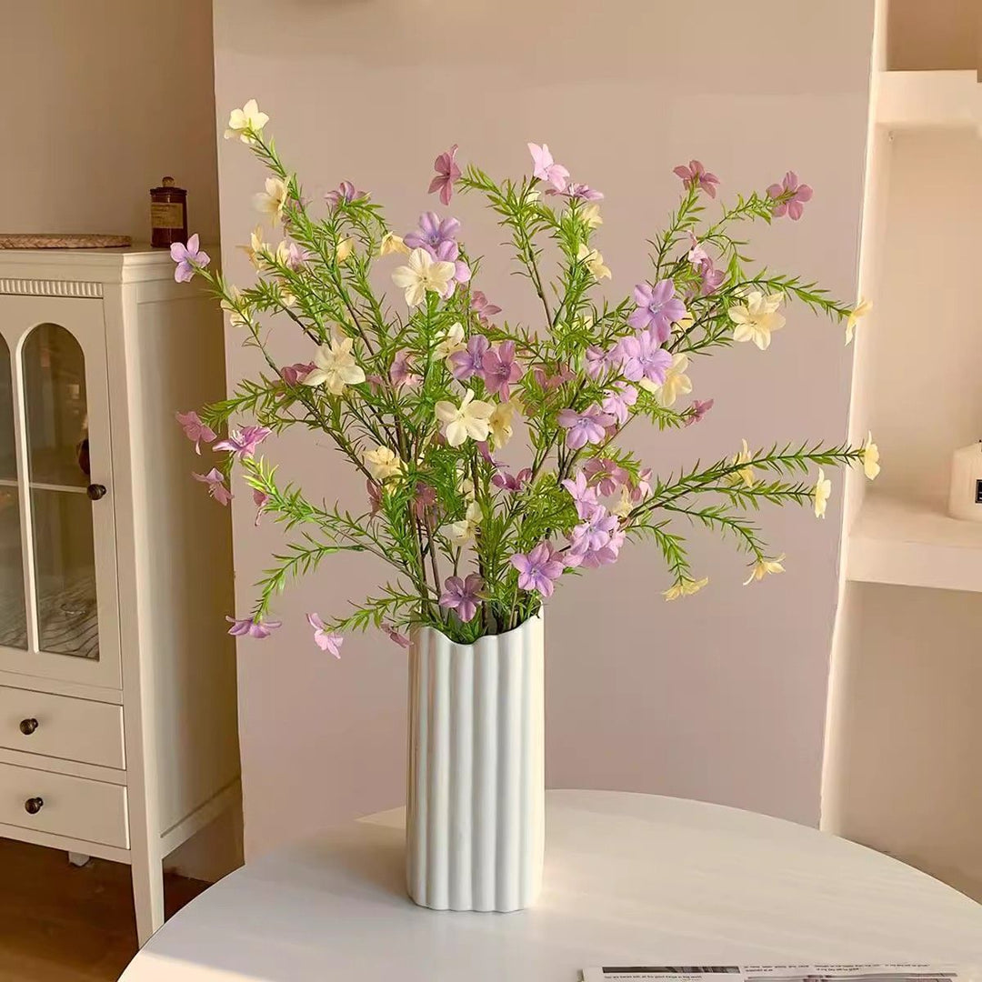 Lebensechte Blumenarrangement mit eleganter Vase