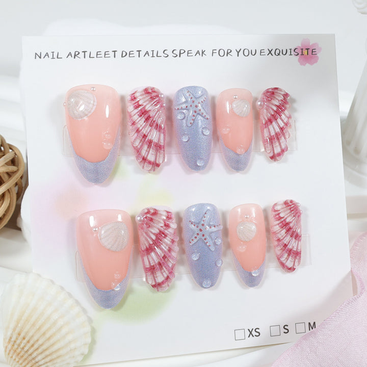 Kunstnagelset mit maritimen Muschel- und Sternenmotiven Karnz