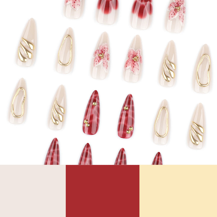 Kunstvolle Stiletto-Nägel mit eleganten Blumendesigns und Glitzerakzenten Karnz