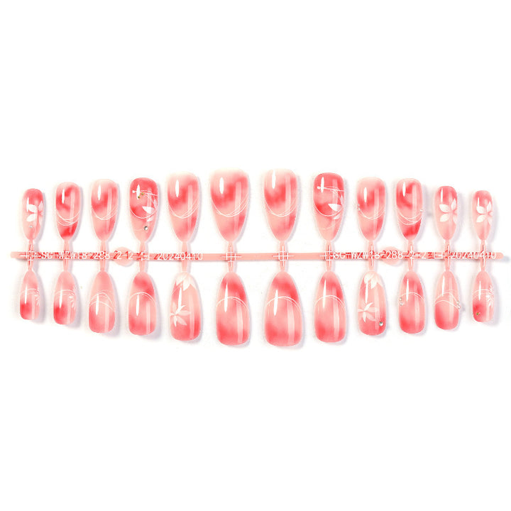 Kunstnagelset mit elegantem Ombre-Design und floralem Akzent Karnz