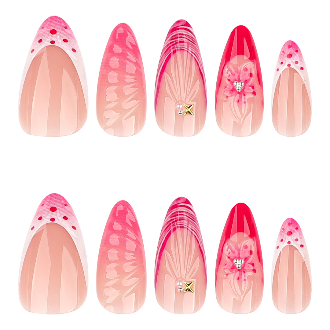 Kunstvolle Stiletto-Nägel mit floralem Design und Glitzerakzenten Karnz