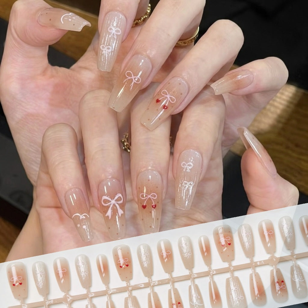 Dekorativer Press-On-Nagelset mit eleganten Schleifenmustern