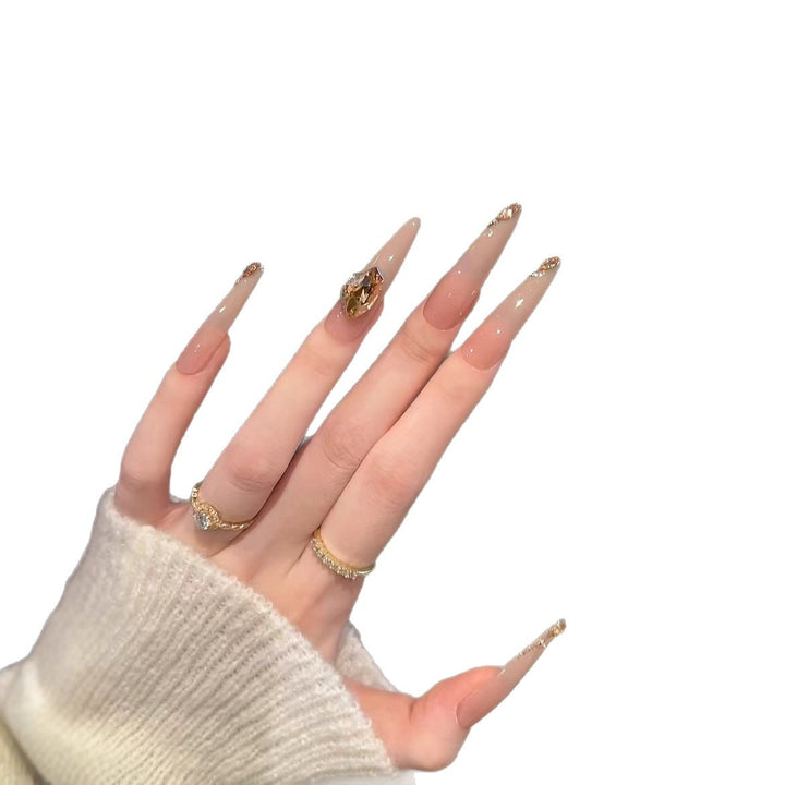 Künstlerische Stiletto-Nagelverlängerungen mit Edelsteinakzenten