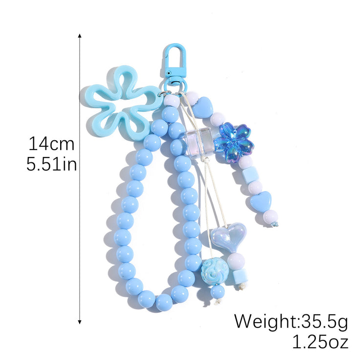 Verspielter Schlüsselanhänger mit Blüten- und Schmetterlingsdetails Karnz