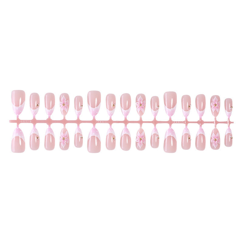 Kreatives Kunstnagelset mit zarten Blüten- und Glitzerdetails Karnz