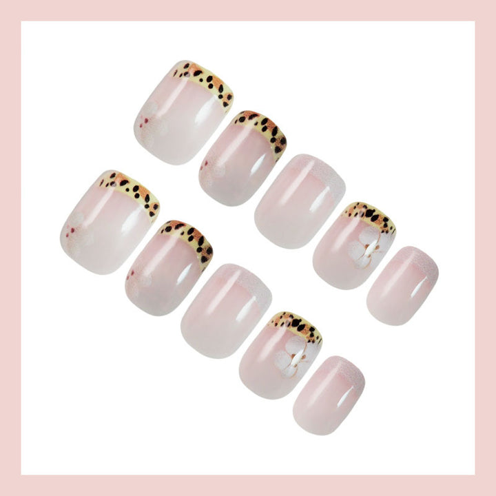 Kunstnagelset mit eleganter französischer Spitze und floralem Akzent Karnz