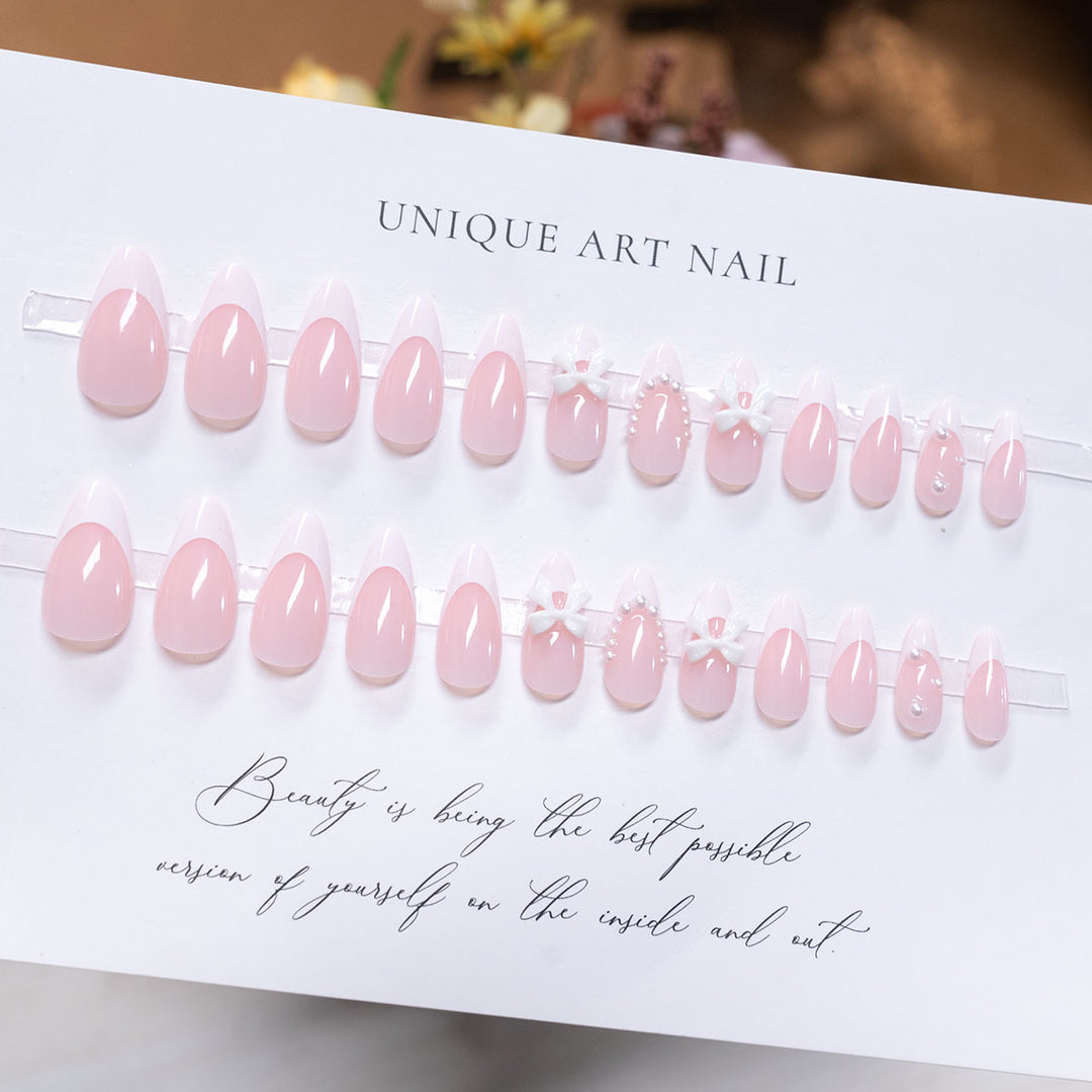 Dekorative Press-On-Nagelkunst mit Schleifenakzenten