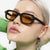 Damen quadratische Sonnenbrille mit hochglänzendem transparentem Rahmen und polarisierenden Gläsern Karnz
