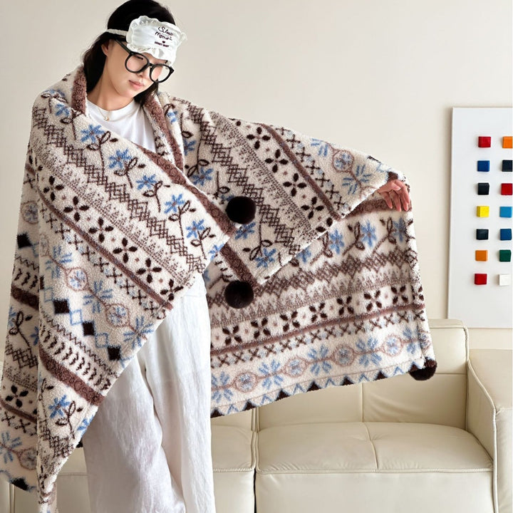 Große kuschelige Wohndecke im Nordic-Boho-Muster mit Pompon-Quasten