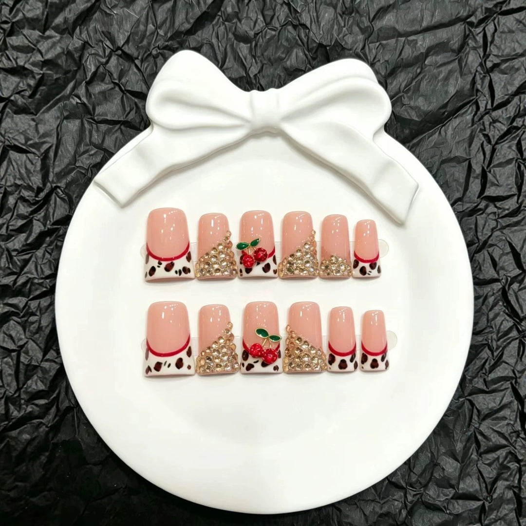 Dekorativer Press-On Nagelkunst-Set mit glamourösen Strasssteinen und Kirschakzenten