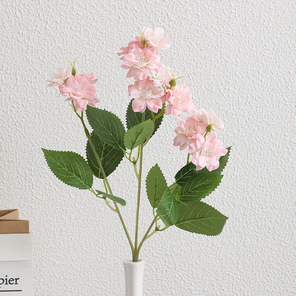 Kunstblumenarrangement mit zarten weißen Blüten Karnz