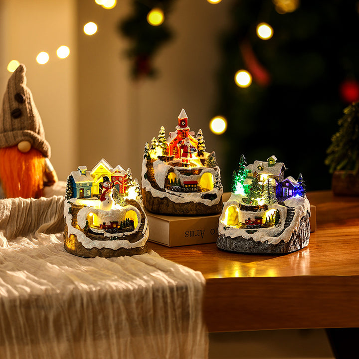 Beleuchtete Weihnachtsdorf-Szene mit Schneemann Karnz