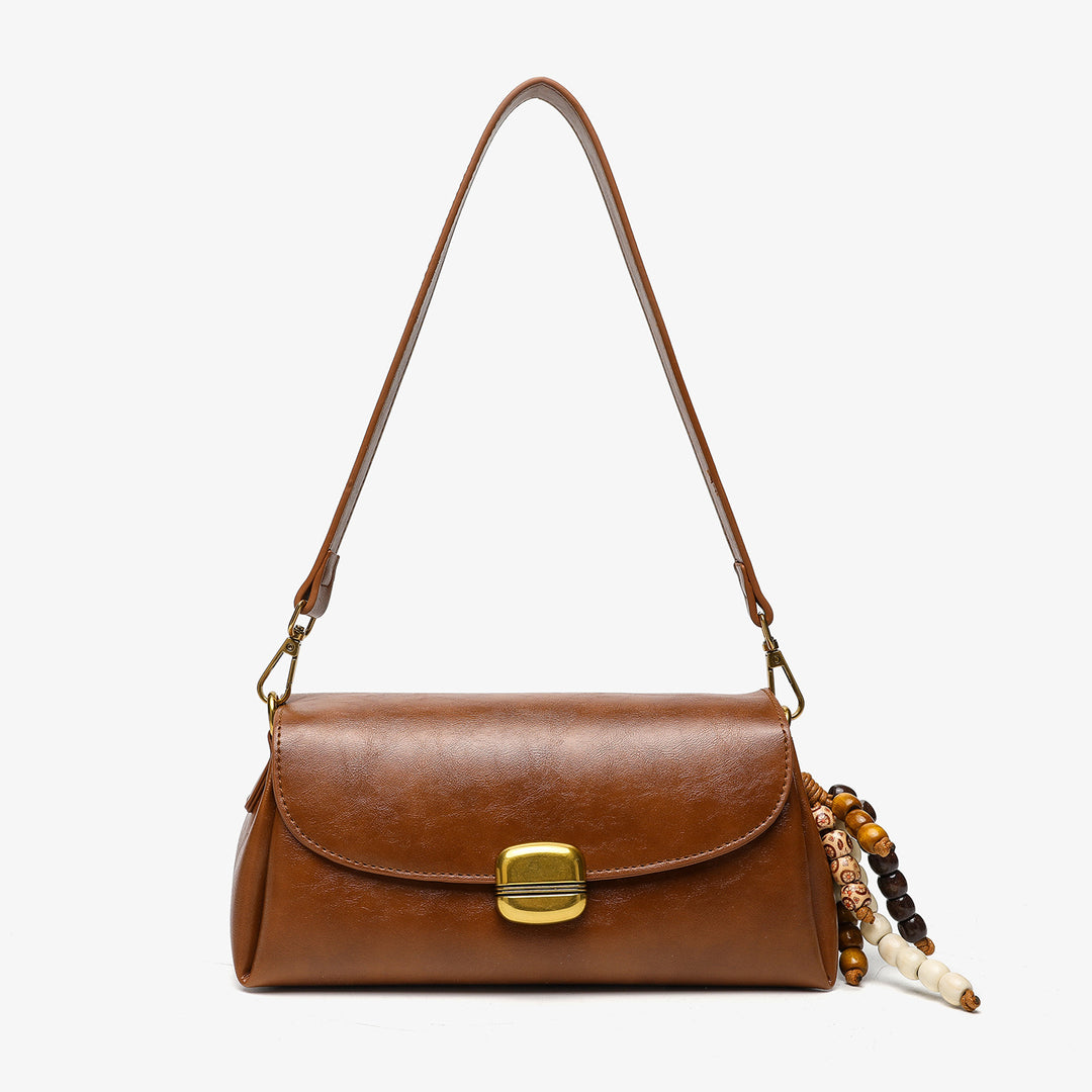Elegante Handtasche mit dekorativem Perlenanhänger