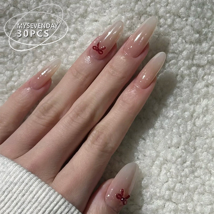 Elegante Stiletto Press-On Nägel mit dekorativen Schleifenakzenten Karnz