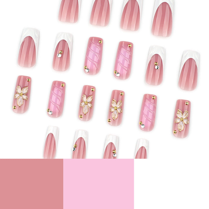Glamouröse Gel-Nägel mit floralem Akzent und Glitzerdetails Karnz