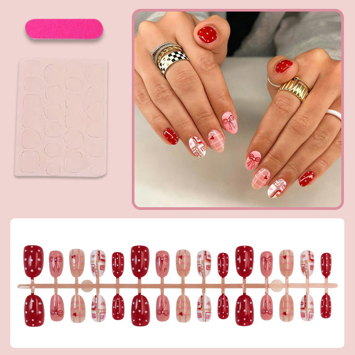 Kunstnagelset mit bezaubernden Herz- und Schleifenmustern Karnz