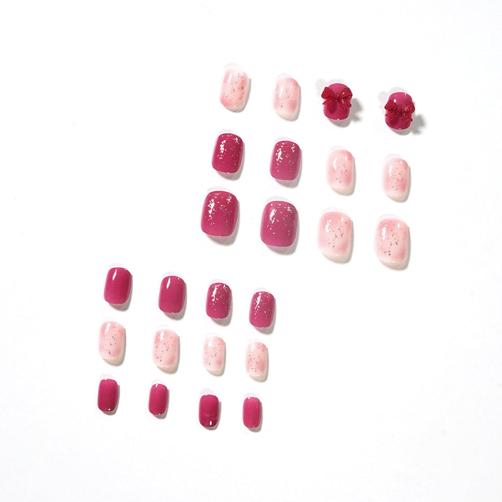Künstliche Nagelkunst mit Glitzerverzierungen und niedlichem Schleifenmotiv Karnz
