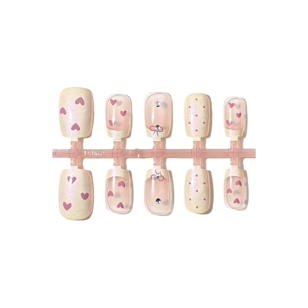 Dekorativer Press-On-Nagelset mit Herz- und Bogenmotiven