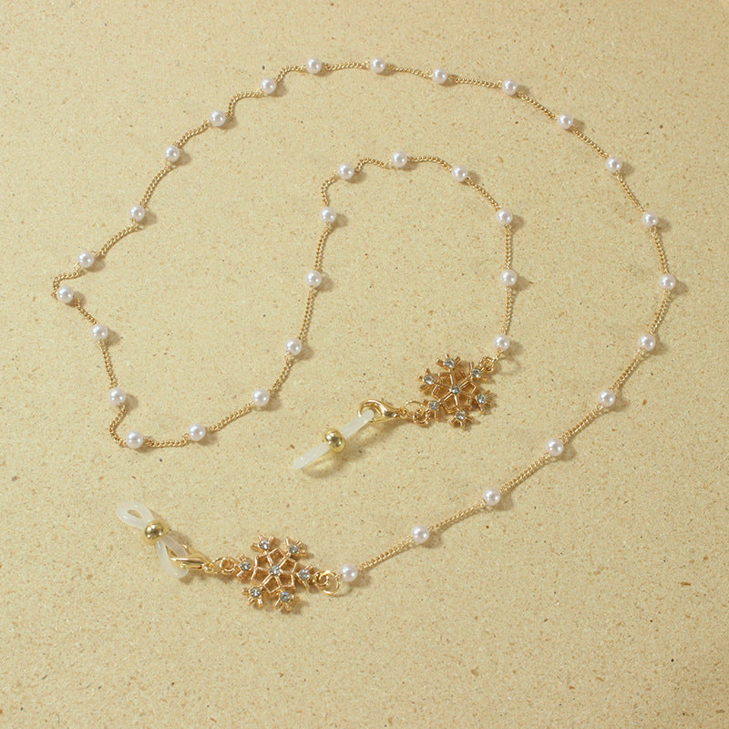 Elegante Brillenhalterkette mit Perlen und Schneeflockenanhänger Karnz