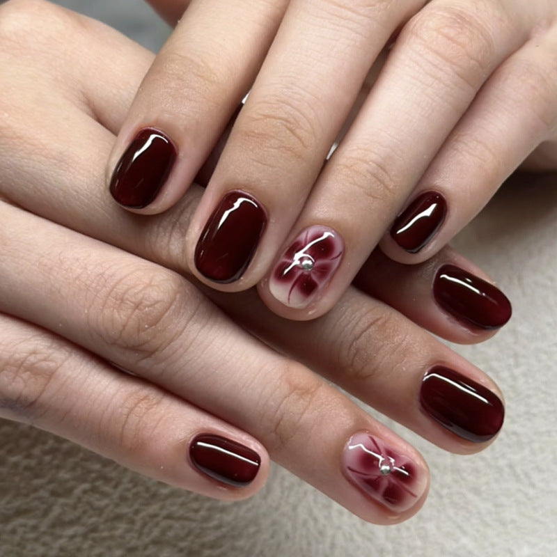 Elegante Nagelkunst mit Glitzer- und Blumenelementen Karnz