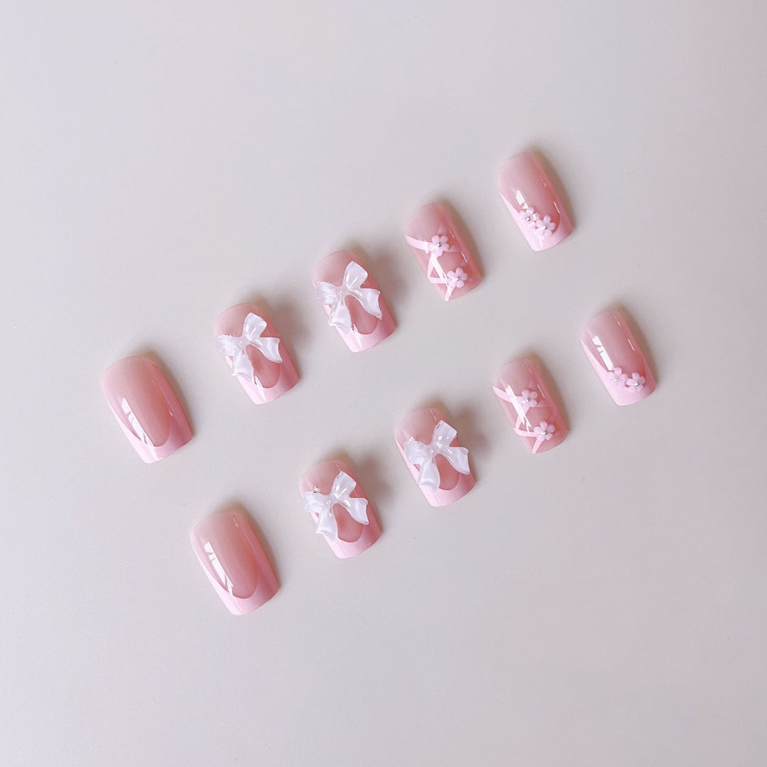 Kunstnagelset mit filigranen 3D-Blüten und Schleifen Karnz