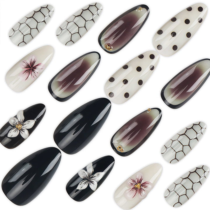 Künstlerisches Stiletto Press-On Nagelset mit Punkten und floralen Designs Karnz