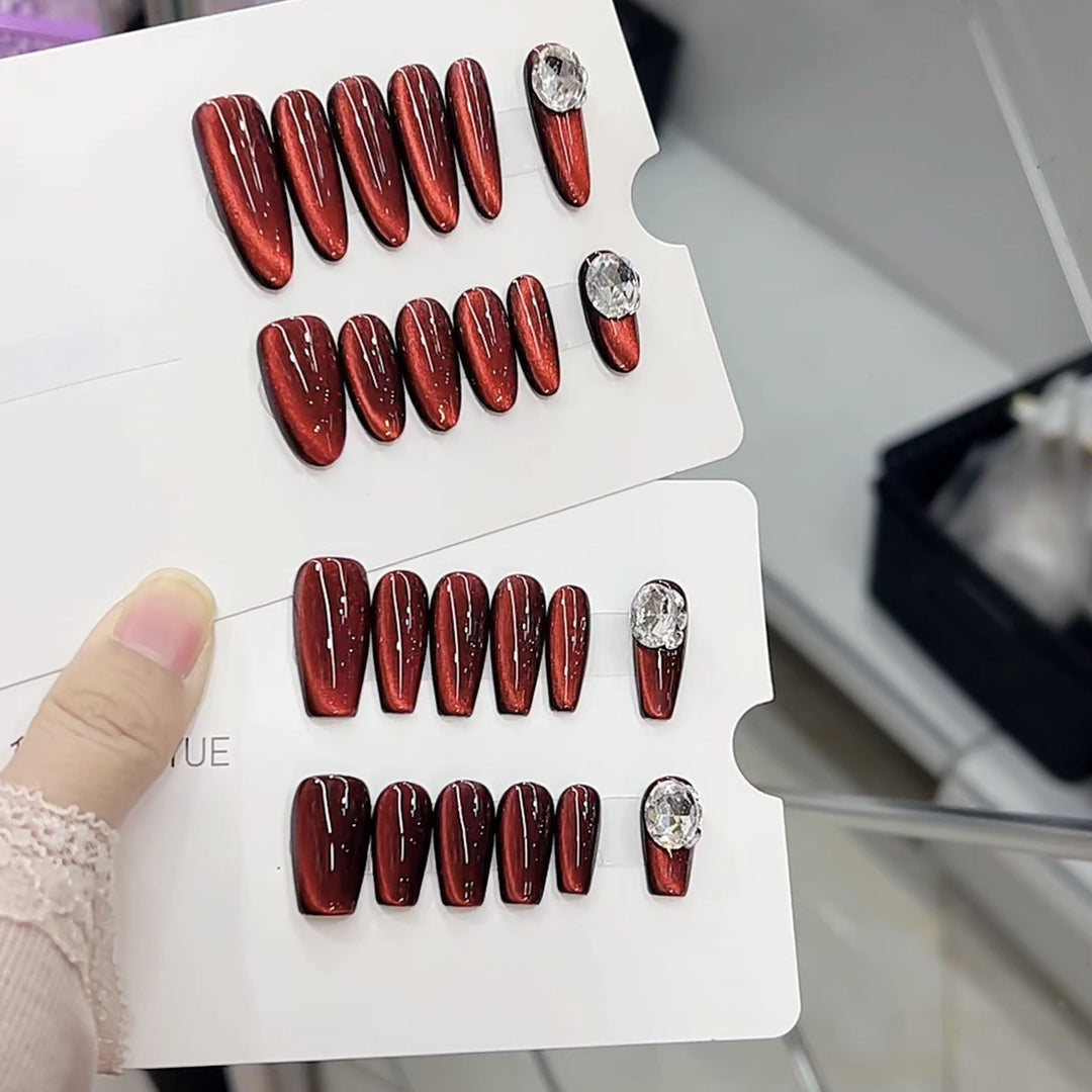 Glänzendes Stiletto Press-On Nagelset mit dekorativen Edelsteinen Karnz