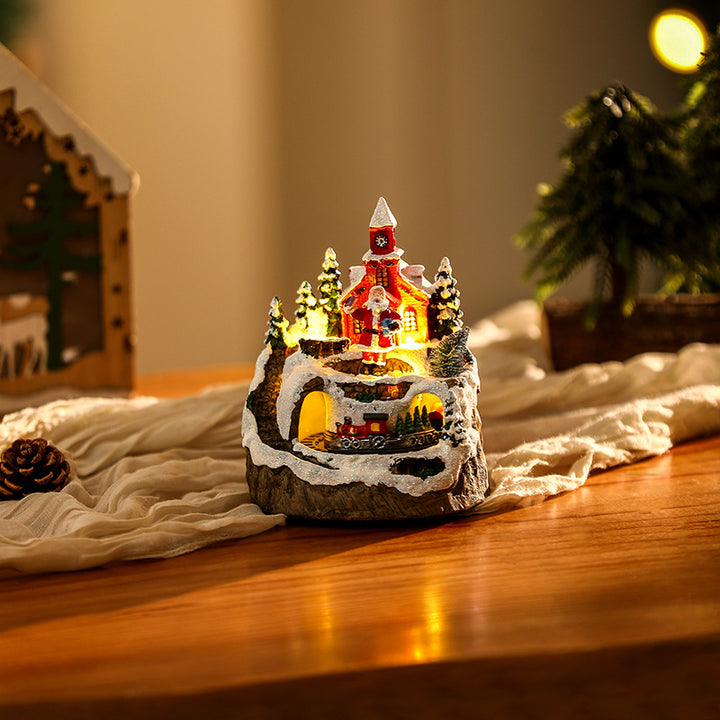 Beleuchtete Weihnachtsdorf-Szene mit Schneemann Karnz