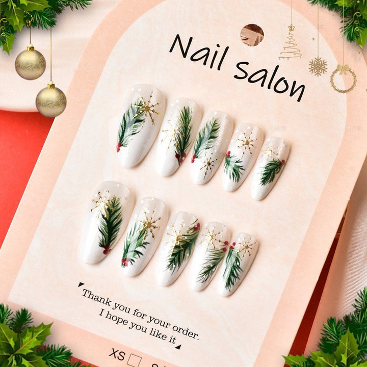 Kunstnagelset mit eleganten Weihnachtsmotiven und goldenen Akzenten Karnz