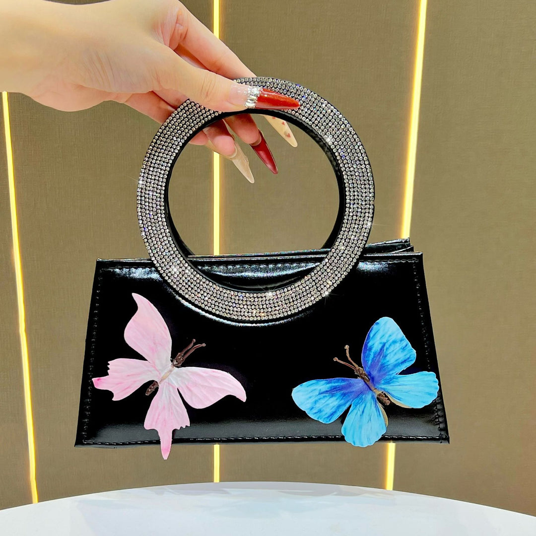 Künstlerische mit Schmetterlingen verzierte Handtasche