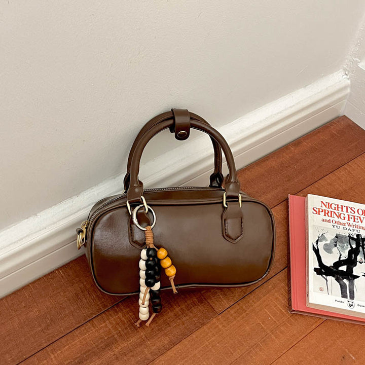 Vintage-inspirierte glänzende Handtasche