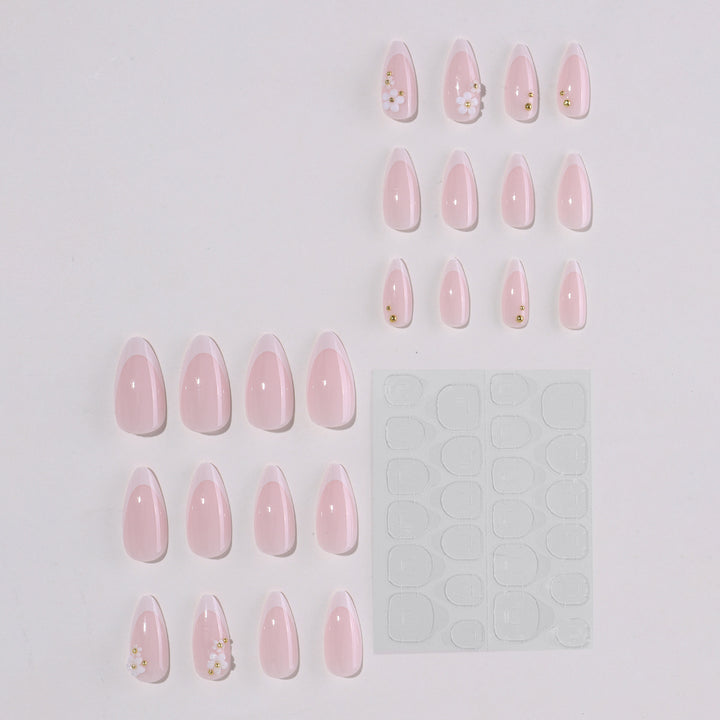 Kunstnagelset mit eleganten Blütenakzenten und Glitzer Karnz