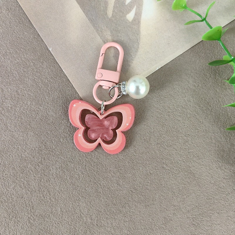 Schlüsselanhänger mit Schmetterling und Perlenakzent Karnz