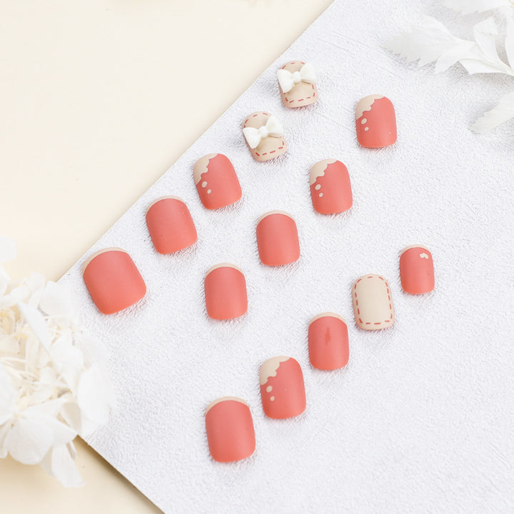 Kunstvolle Nagelnägel mit dekorativen Bogenmotiven und French-Spitzen Karnz